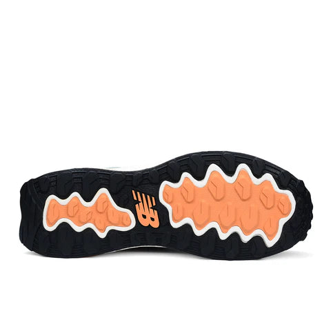 Sole of a shoe with orange and white patterns on a white background