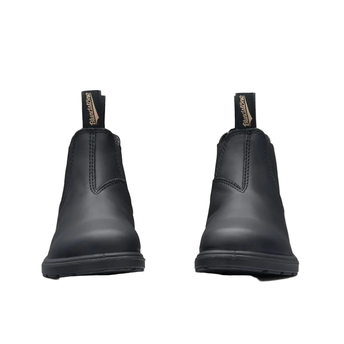 Pair of black rubber boots on a beige background
